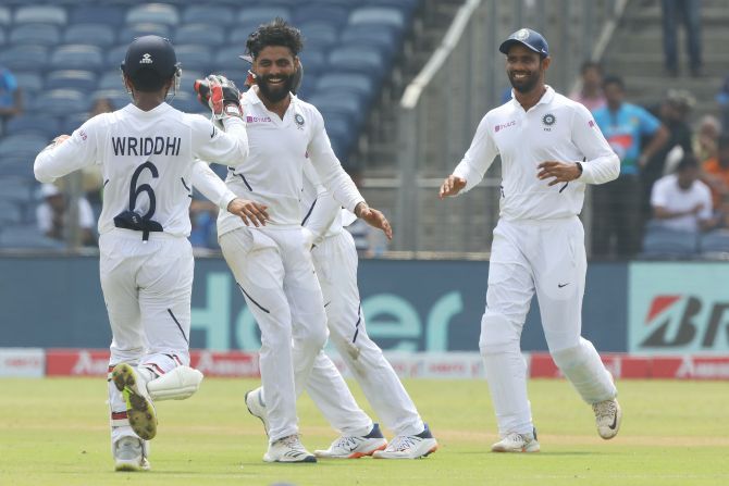 Ravindra Jadeja celebrates with teammates after taking the wicket of Temba Bavuma