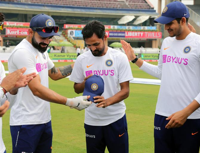 Shahbaz Nadeem, who replaced fellow left-arm spinner Kuldeep Yadav, is presented his Test cap by skipper Virat Kohli on Saturday