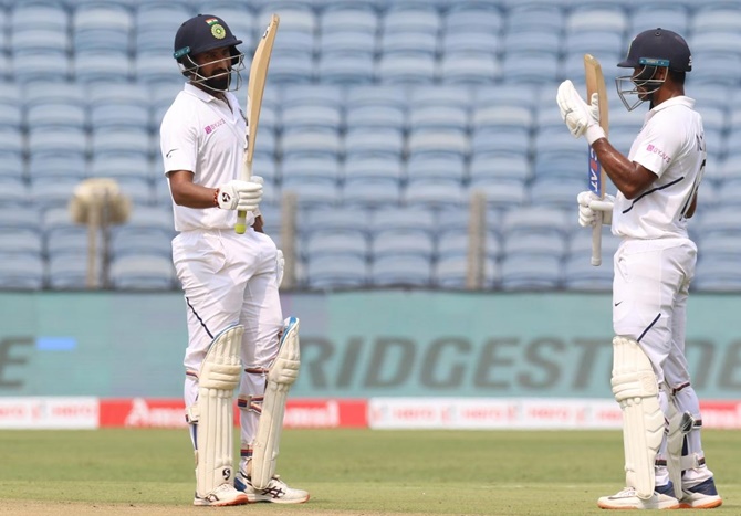 Cheteshwar Pujara celebrates his fifty. 