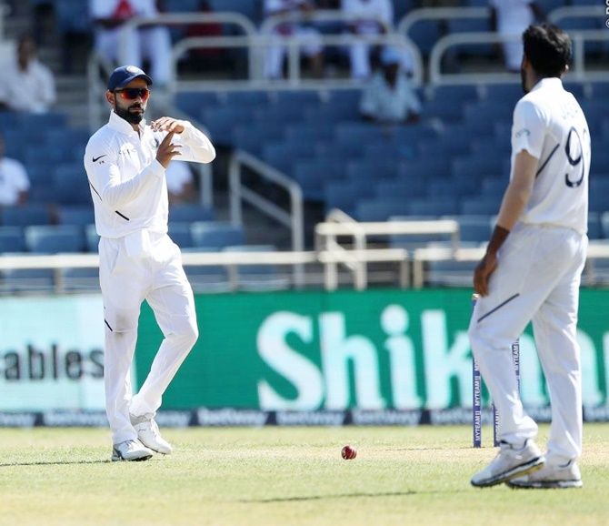 Virat Kohli calls for the DRS after Jasprit Bumrah traps Roston Chase in front of the stumps