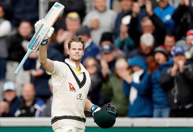 Australia's Steve Smith raises his bat as he leaves the ground after being dismissed for 211 runs on Day 2 of the 4th Ashes Test at Old Trafford in Manchester on Thursday