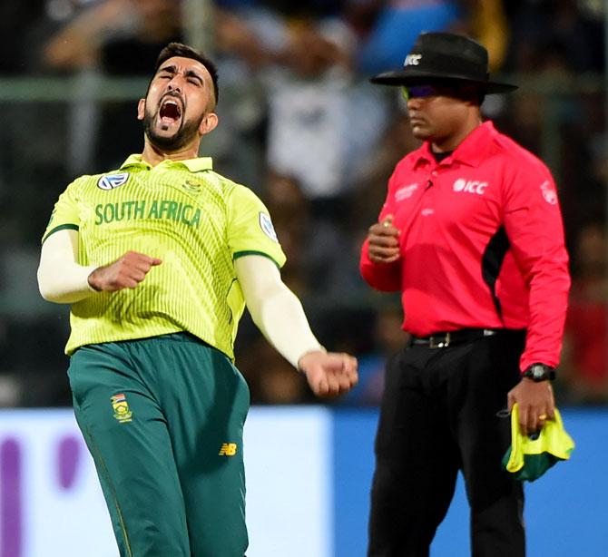 South African bowler Tabraiz Shamsi celebrates after taking the wicket of Indian batsman Shikhar Dhawan