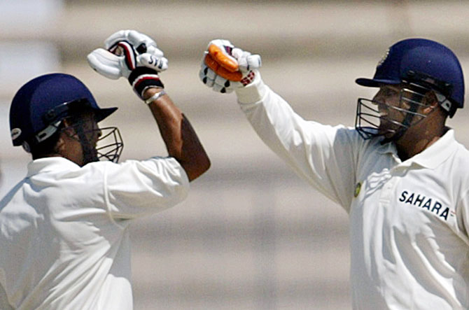 Virender Sehwag, right, celebrates with Sachin Tendulkar after completing his triple century during the first Test against Pakistan in Multan, on March 29, 2004