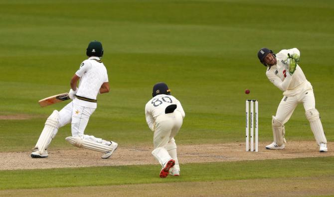 England's Jos Buttler misses the stumping of Pakistan's Shan Masood