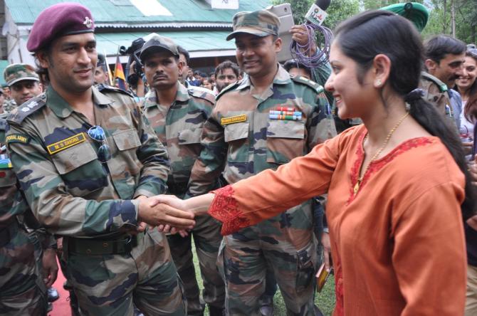 Kumudini Panda is greeted by Mahendra Singh Dhoni