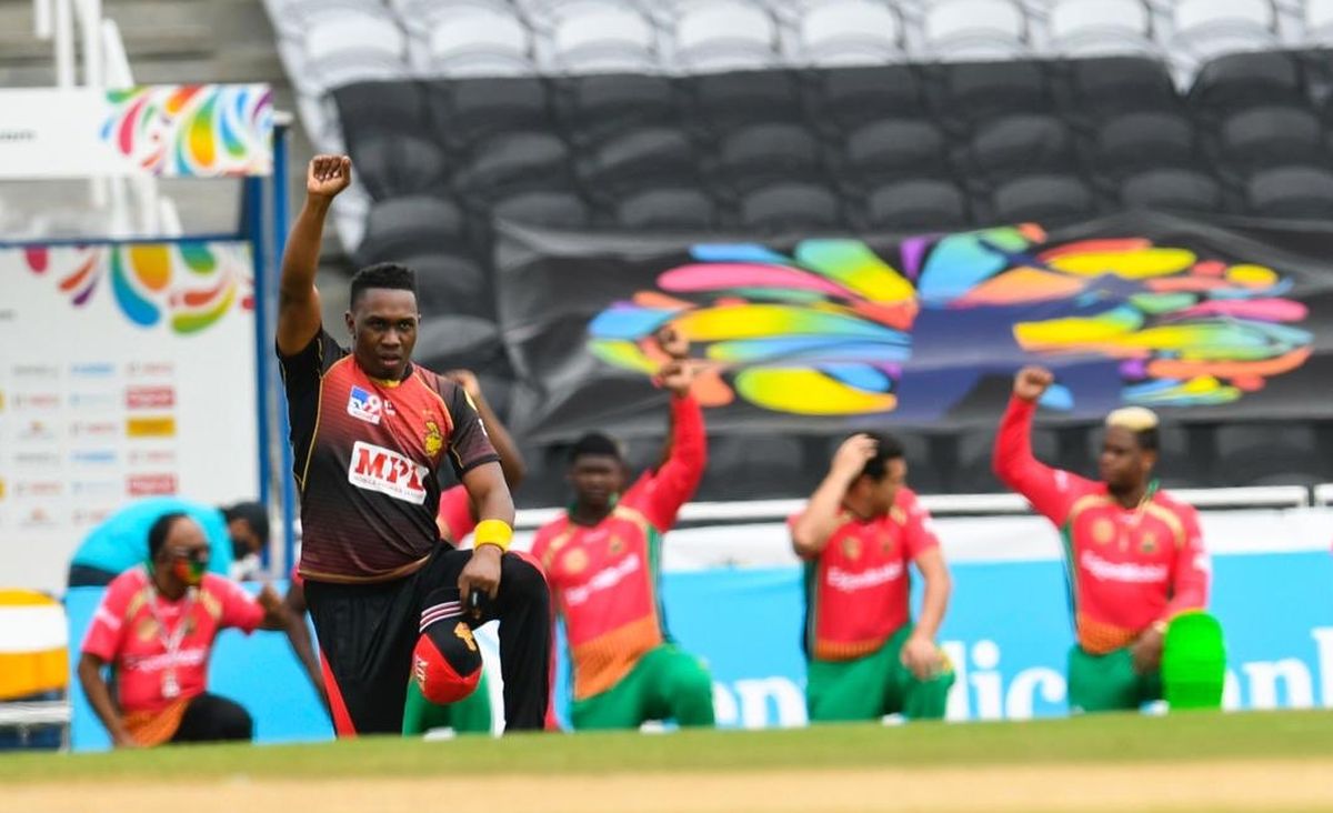 Trinbago Knight Riders' Dwayne Bravo takes a knee before the CPL match against Guyana Amazon Warriors