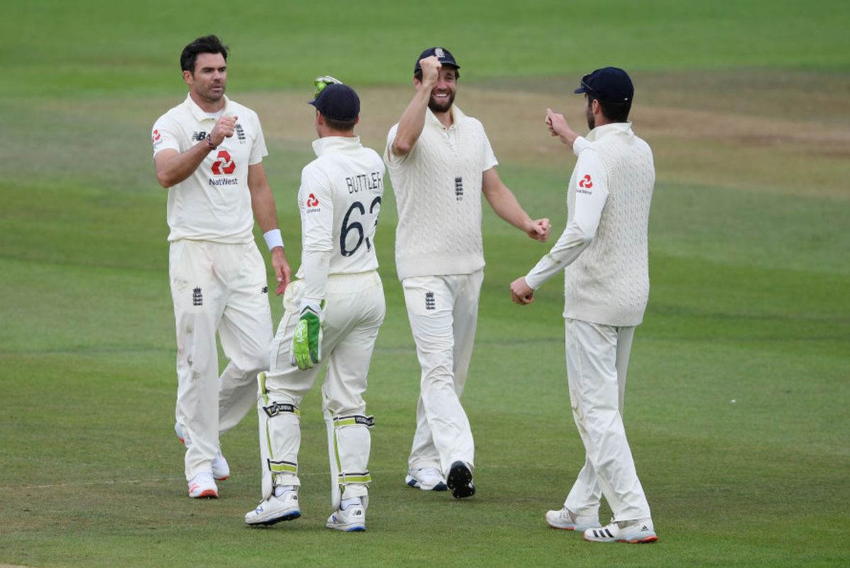 James Anderson is congratulated by Jos Buttler after taking his fifth wicket on dismissing Naseem Shah