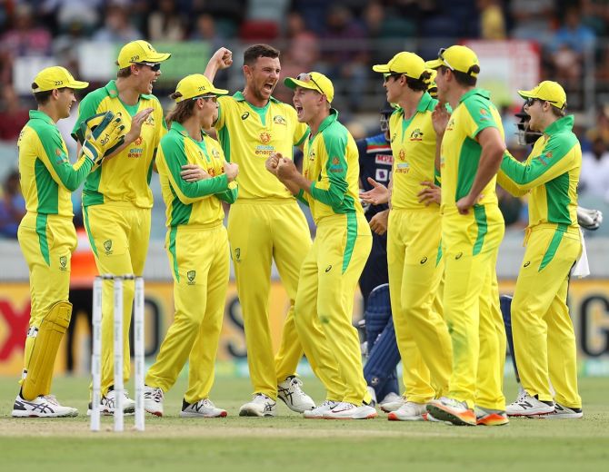 Australia's players celebrate the wicket of Virat Kohli