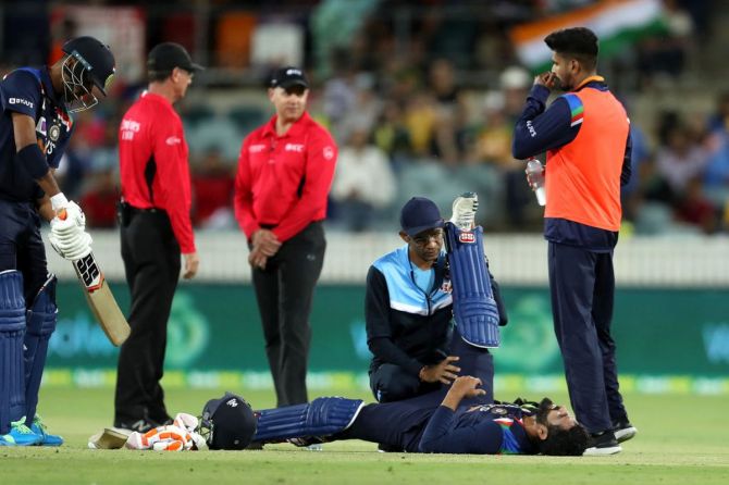 Ravindra Jadeja seeks medical attention during the first Twenty20 International against Australia at Manuka Oval in Canberra on Friday