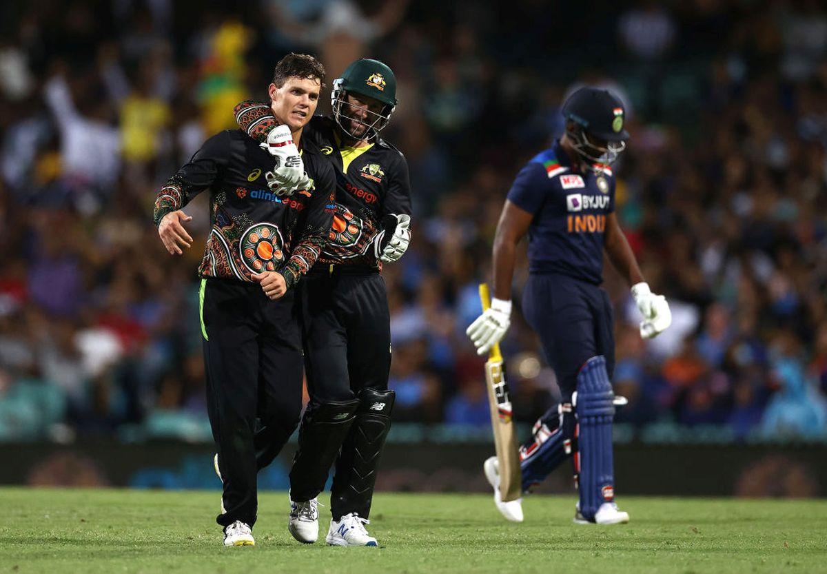 Mitchell Swepson celebrates with Matthew Wade after taking the wicket of Sanju Samson