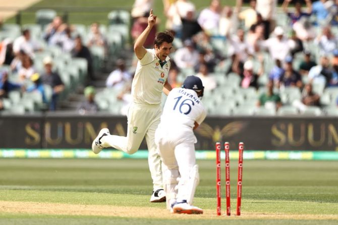 Pat Cummins celebrates on his follow through after taking the wicket of Mayank Agarwal.