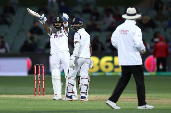 Virat Kohli gestures to umpire Bruce Oxenford after being called for one short run.