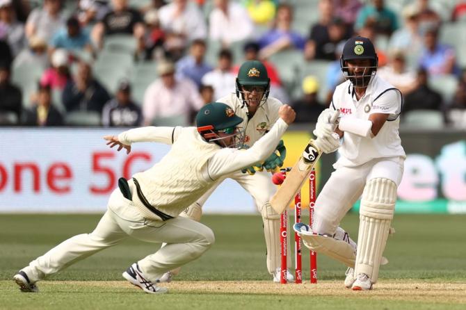 Australia's Travis Head attempts to catch out Cheteshwar Pujara on Day 1 of the 1st Test match at Adelaide Oval in Adelaide on Thursday