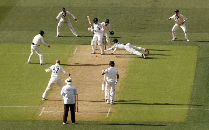 Matthew Wade dives as he attempts to catch Cheteshwar Pujara off the bowling of Nathan Lyon on Day 1 of the first Test at Adelaide Oval on Thursday