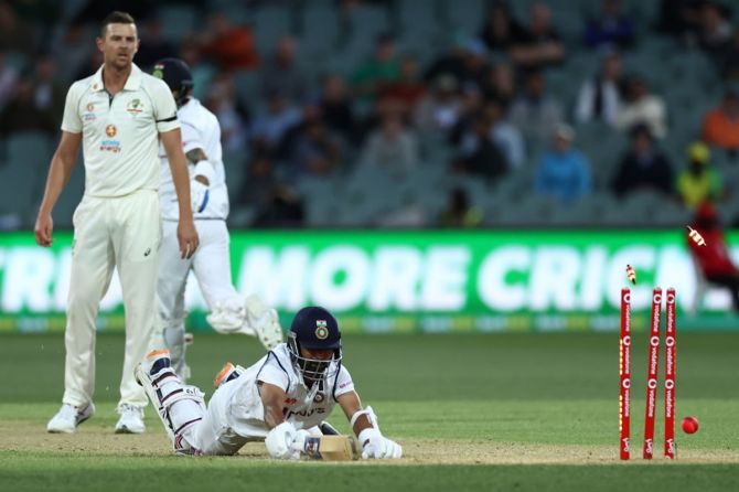 Josh Hazlewood watches anxiously as Ajinkya Rahane dives to make his ground and avoids being run-out