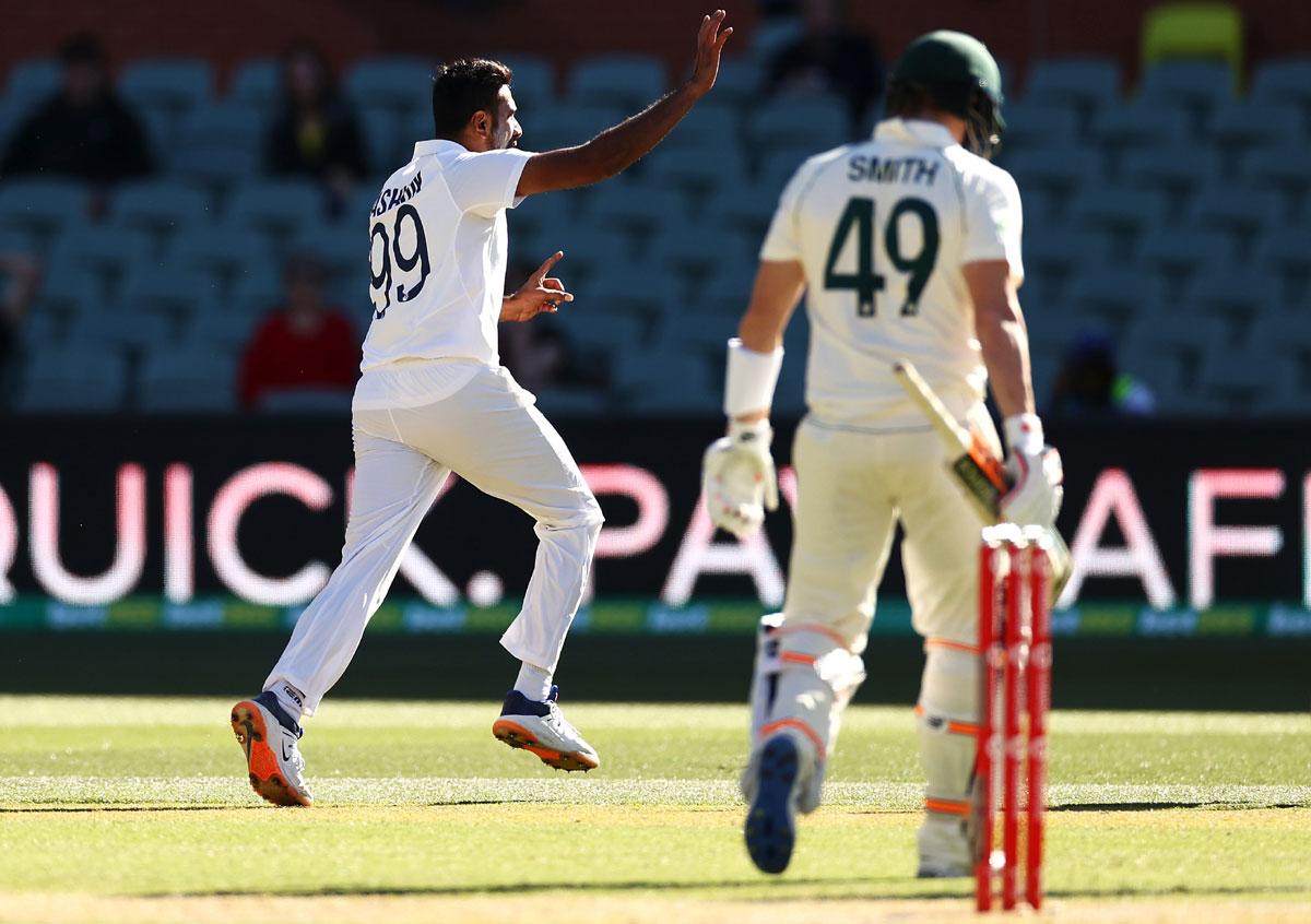 Steve Smith walks back as the India's players celebrate his dismissal by Ravichandran Ashwin