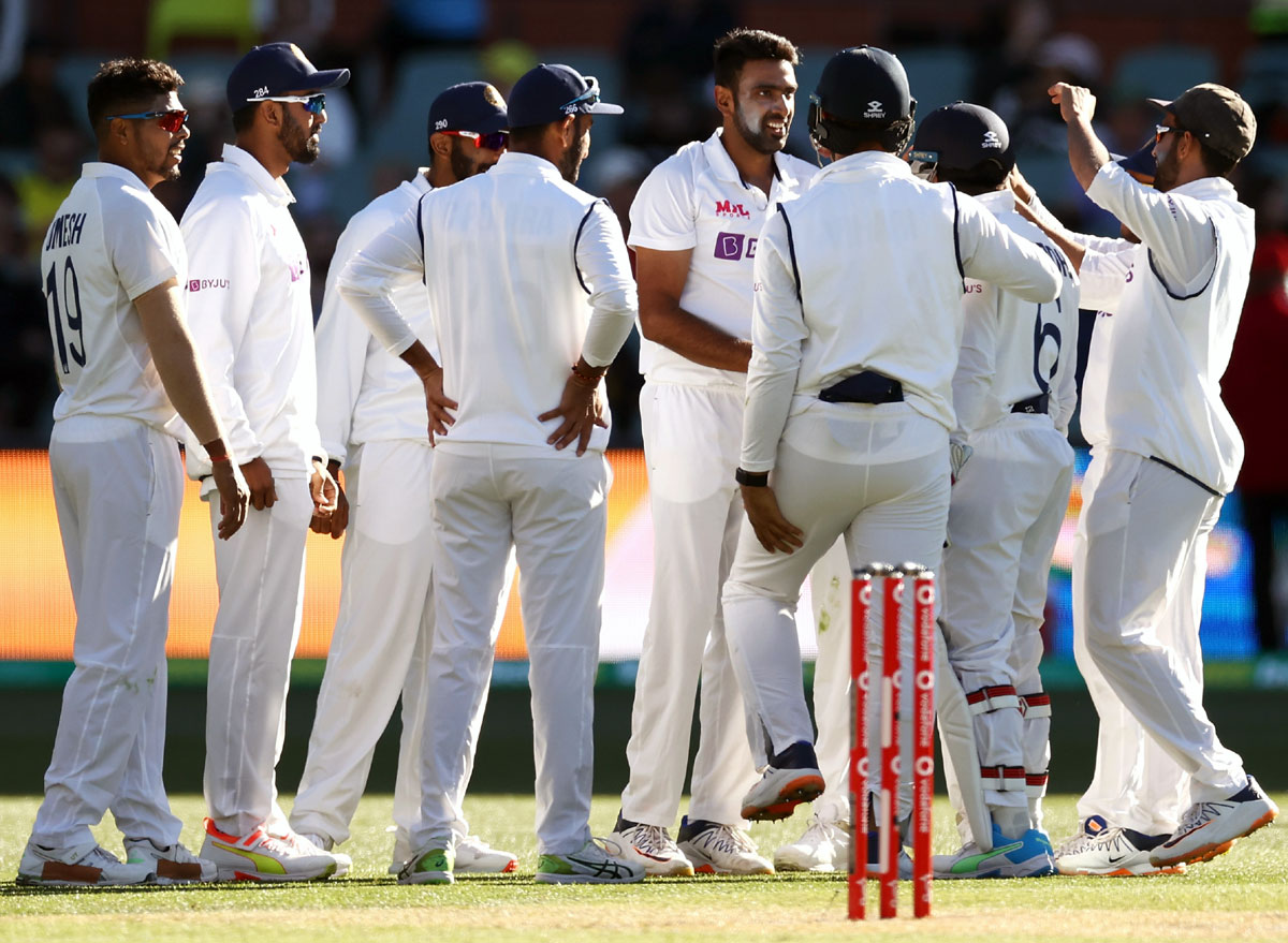 Ravichandran Ashwin celebrates with his India teammates after catching Travis Head off his own bowling