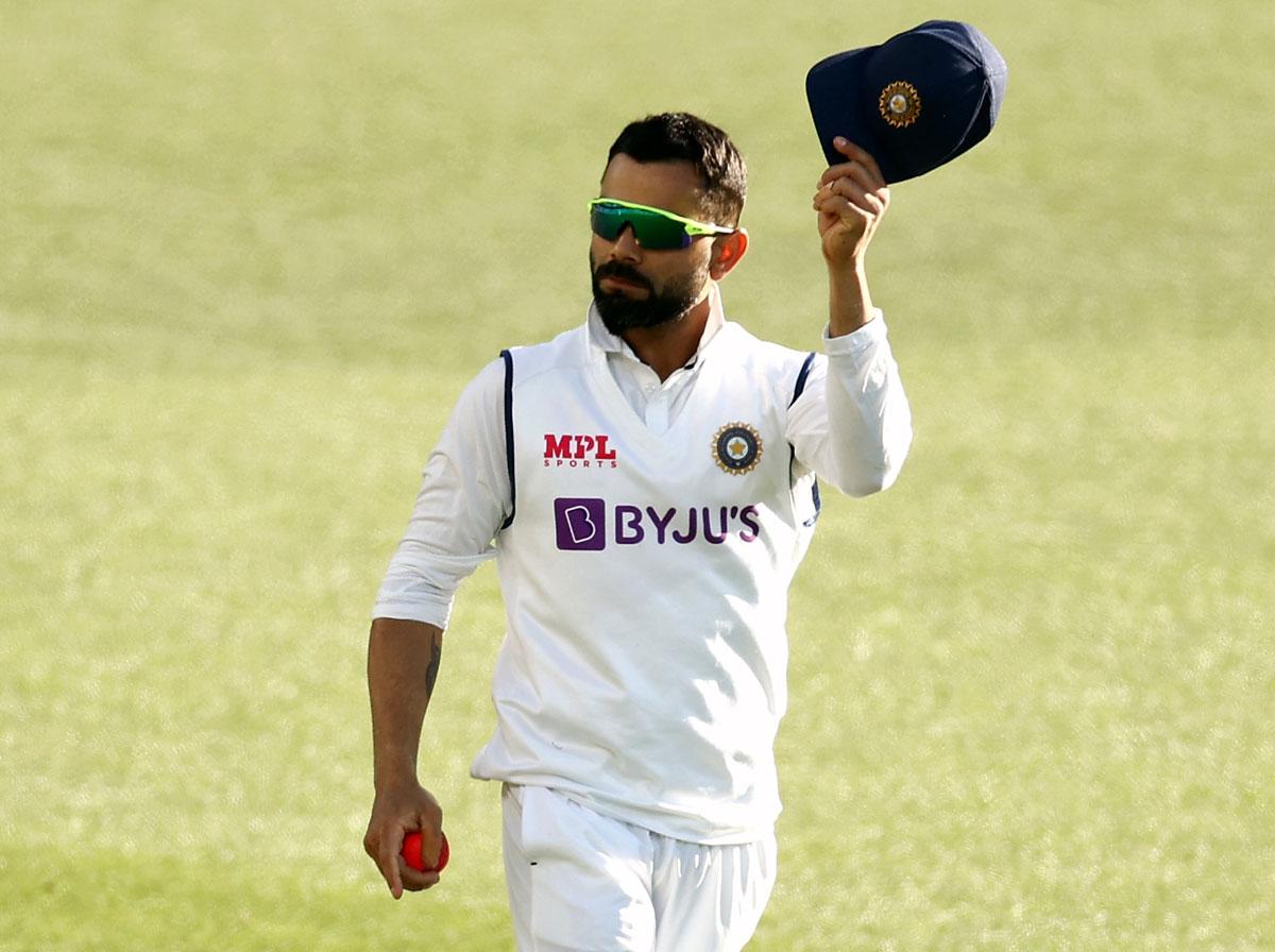 Virat Kohli celebrates taking the catch to dismiss Cameron Green.