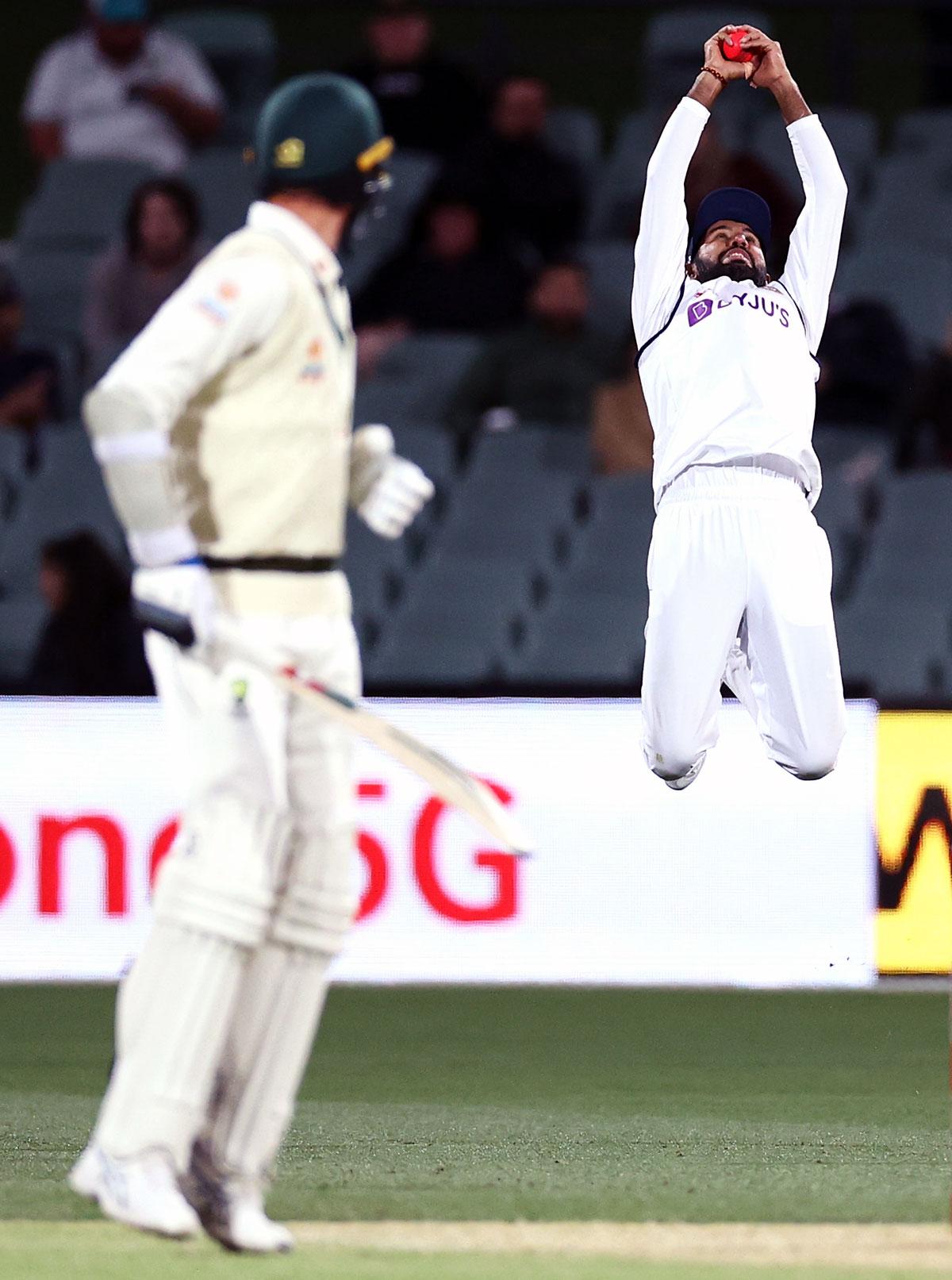 Cheteshwar Pujara takes the catch in the slips to dismiss Josh Hazlewood off Umesh Yadav's bowling