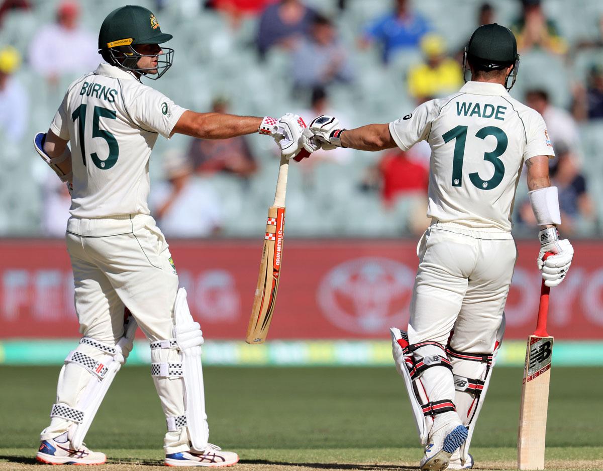 Openers Joe Burns and Matthew Wade fist pump during Australia's second innings on Saturday, Day 3 of the Day-Night first Test against India, at the Adelaide Oval 