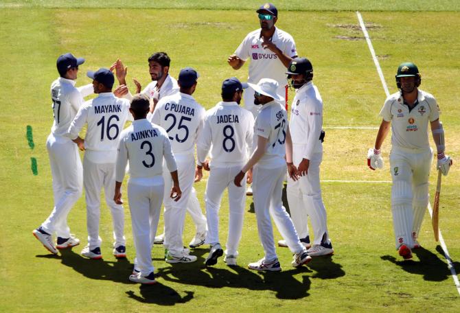 Jasprit Bumrah celebrates dismissing Joe Burns.