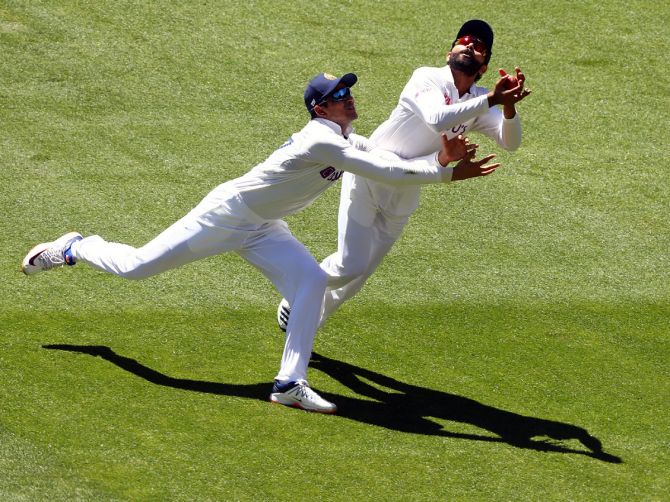 Ravindra Jadeja collides with teammate Shubman Gill as he takes the catch to dismiss Matthew Wade.