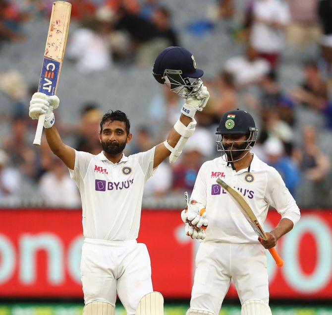India stand-in captain Ajinkya Rahane celebrates after completing his century as Ravindra Jadeja applauds during Day 2 of the second Test against Australia, at the Melbourne Cricket Ground, on Sunday. 
