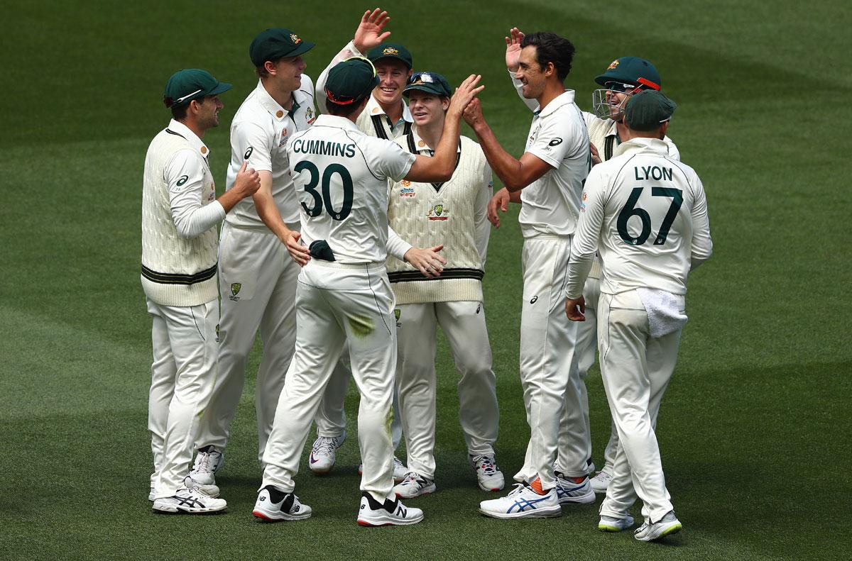 Pat Cummins celebrates after taking the catch to dismiss Ravindra Jadeja.