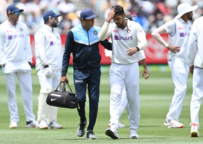 Umesh Yadav leaves the field after sustaining an injury during Day 3 of the second Test, in Melbourne, on Monday