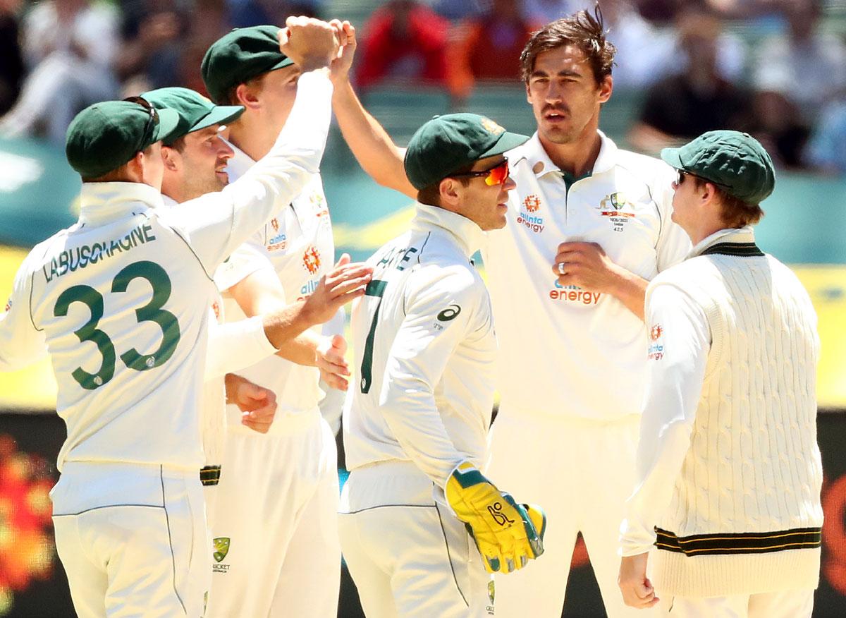 Mitchell Starc celebrates the dismissal of Mayank Agarwal