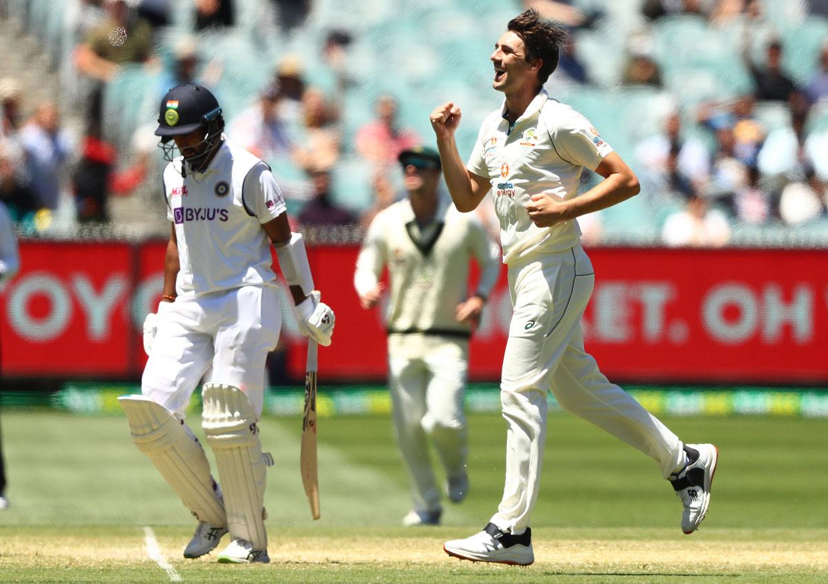 Pat Cummins celebrates taking the wicket of Cheteshwar Pujara