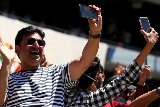 An Indian fan captures the winning moment on his mobile