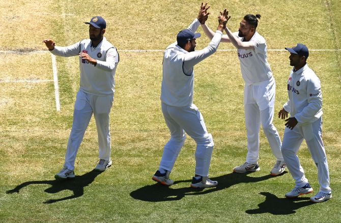 Mohammed Siraj celebrates with teammates after dismissing Nathan Lyon on Tuesday