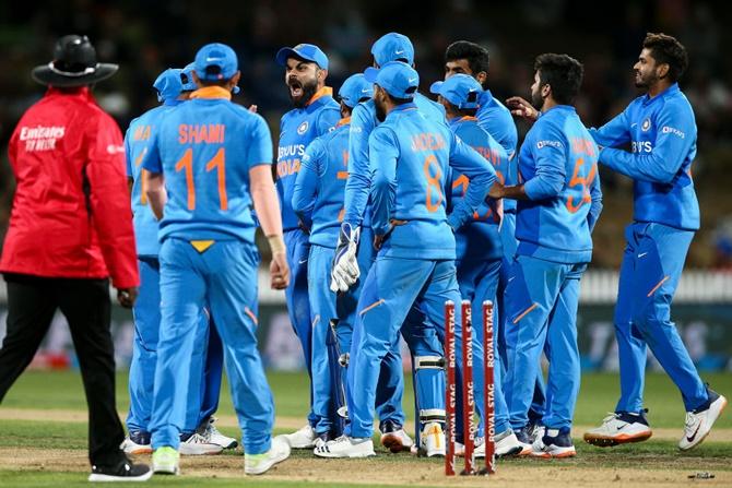 India's players celebrate the dismissal Henry Nicholls in the first ODI against New Zealand, at  Seddon Park