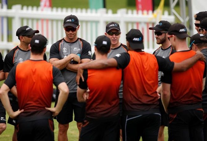 New Zealand players huddle around coach Gary Stead during a nets session. 