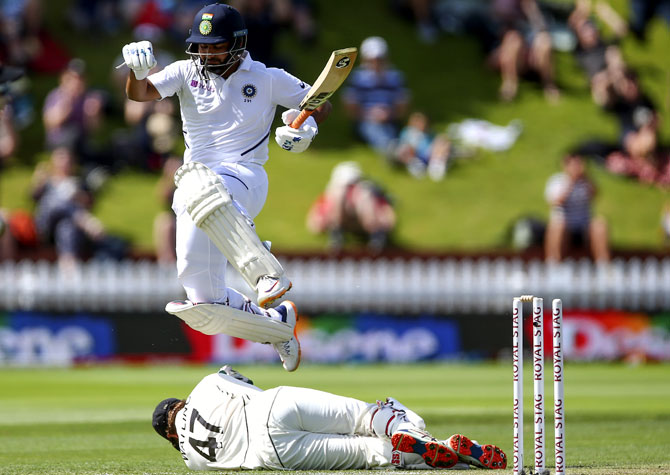 Rishabh Pant leaps over New Zealand wicketkeeper BJ Watling after he is run-out by a direct hit from Ajaz Patel