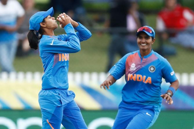 Radha Yadav, left, takes the catch to dismiss Sophie Devine.