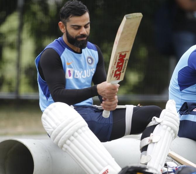 Virat Kohli checks out his bats during Friday's training in Christchurch.