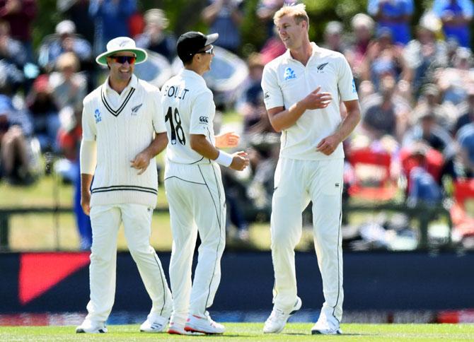 Kyle Jamieson, right, celebrates with team-mates after taking the wicket of Prithvi Shaw