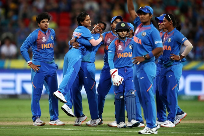India's Poonam Yadav celebrates with teammates after dismissing Australia's Jess Jonassen during the ICC Women's T20 World Cup match on February 21, 2020, in Sydney, Australia.