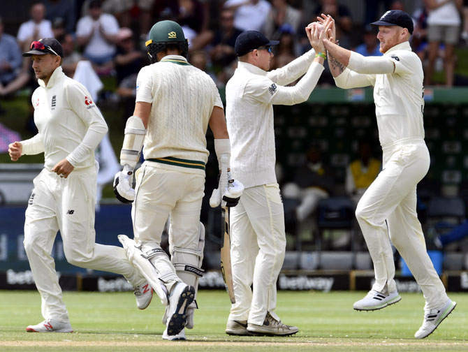 Ben Stokes (right) celebrates with teammates after taking a catch to dismiss Anrich Nortje off the bowling of Stuart Broad
