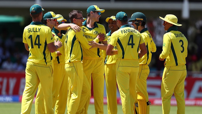 Australia's players celebrate a dismissal in the ICC Under-19 World Cup Group B match against England at De Beers Diamond Oval, in Kimberley, South Africa, on Thursday.