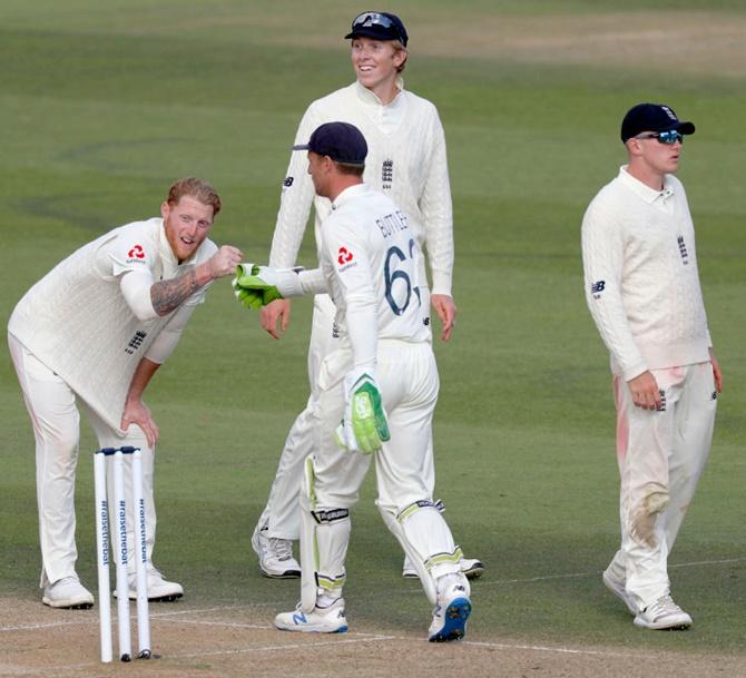 England’s Ben Stokes celebrates with Jos Buttler after taking the wicket of West Indies' Shane Dowrich