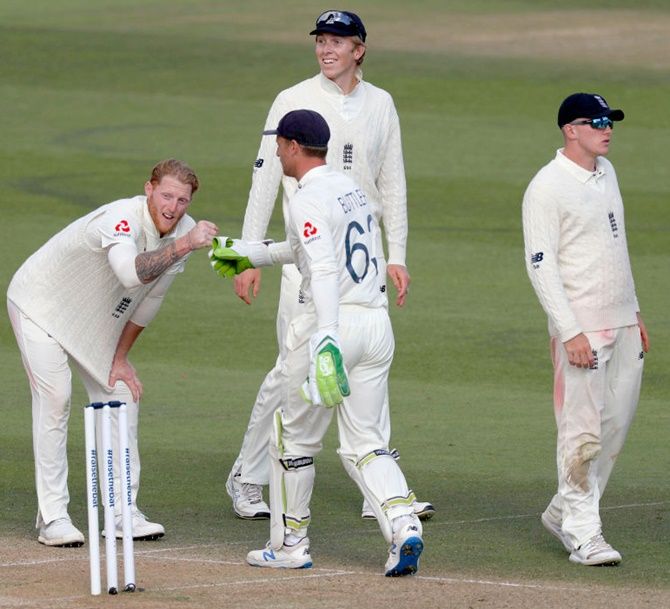 England’s Ben Stokes celebrates with Jos Buttler after taking the wicket of West Indies' Shane Dowrich