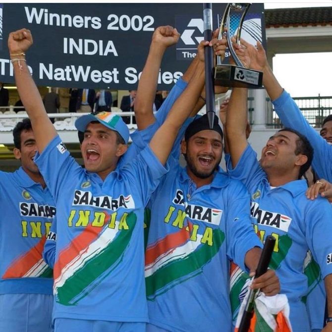 The Indian cricket team celebrate with the trophy 