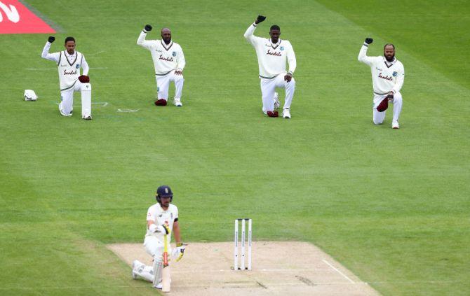 Members of the West Indies team and England's Rory Burns take a knee in support of the Black Lives Matter movement