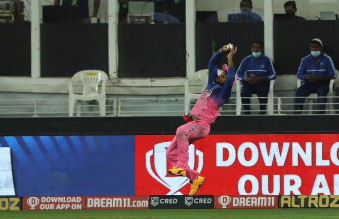Rajasthan Royals' Sanju Samson takes the catch to dismiss Kolkata Knight Riders' Pat Cummins off the bowling of Tom Curran on September30, 2020.