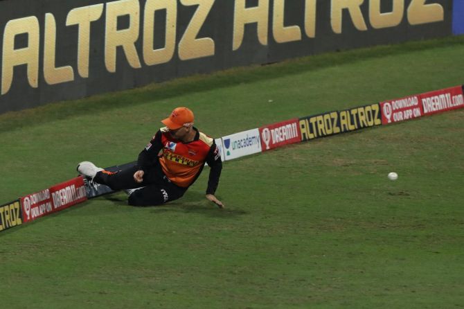 Sunrisers Hyderabad's David Warner puts in a slide at the boundary during the match against Mumbai Indians on November 3, 2020