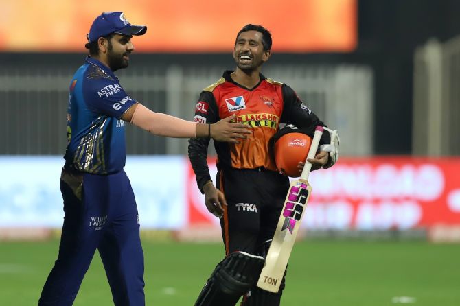 Wriddhiman Saha is congratulated by Rohit Sharma as he walks back after the match.