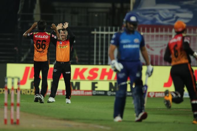 Rohit Sharma walks back as pacer Sandeep Sharma and David Warner celebrate his dismissal